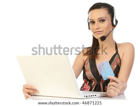 Woman using laptop, holding credit card and making an order via phone