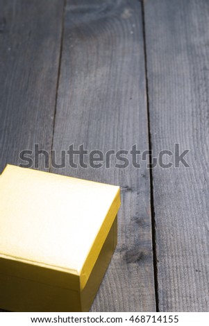 golden gift box on black wood background