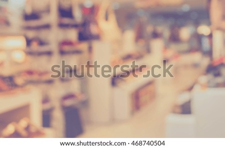 vintage tone blur image of shoe store for background usage.