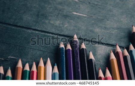 coloring pencils over a textured background. 