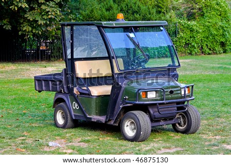 Green vehicle with dump basket for parks