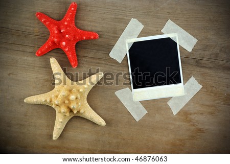 Starfish and wood background with  instant photo frame