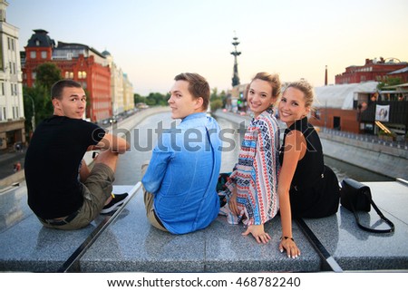 group of young people sitting relaxing in the industrial city