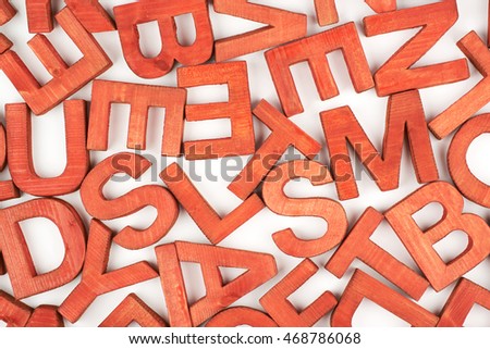 Surface coated with the multiple painted wooden block letters as an abstract backrop composition