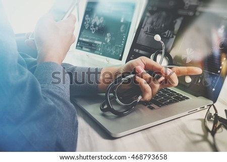 Doctor working with digital tablet and laptop computer with smart phone in medical workspace office and video conference as concept

 Royalty-Free Stock Photo #468793658
