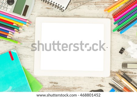 back to school frame with school supplies and tablet with empty screen on wooden table