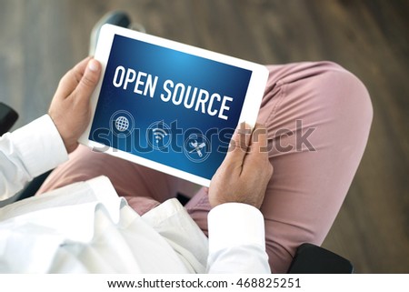 People using tablet pc and OPEN SOURCE concept on screen