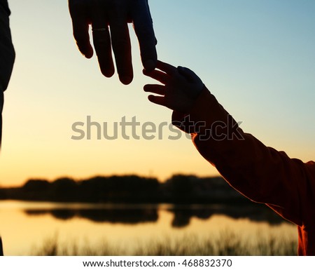 nice silhouette parent and child hands