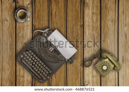 Vintage typewriter and coffee on wood background