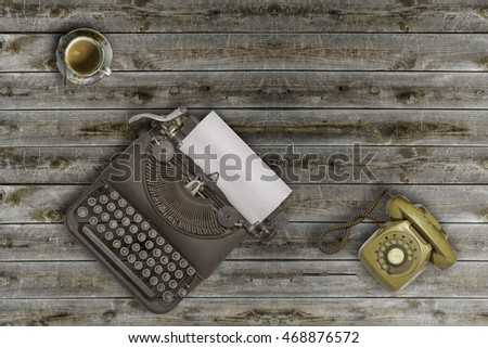 Vintage typewriter and coffee on wood background