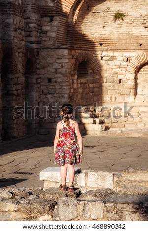 Girl walking among the ruins