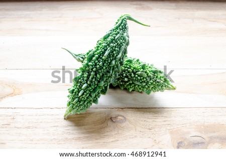 Close up of fresh bitter gourd fruit isolated on wooden background