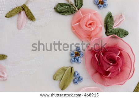 Macro of silk embroidery on damask cloth