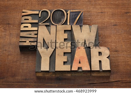 Happy New Year 2017 greeting card - text in vintage letterpress wood type blocks on a grunge wooden background Royalty-Free Stock Photo #468923999