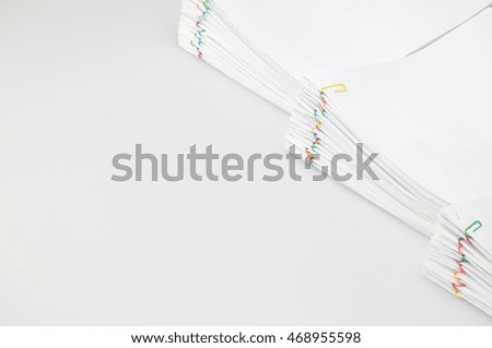Pile overload document of report and receipt with colorful paperclip place on right with white background and copy space. Business and finance concepts rich and successful photography.