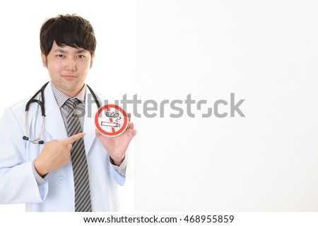 Doctor holds non smoking sign
