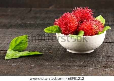 Bowl of Rambutan-Sweet delicious  tropical fruit with leaves.Selective focus photograph.