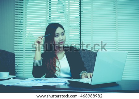 Tired business woman working on her workspace, vintage tone