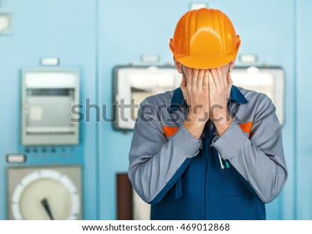 Portrait of stressed despair engineer closed face by two hands Royalty-Free Stock Photo #469012868