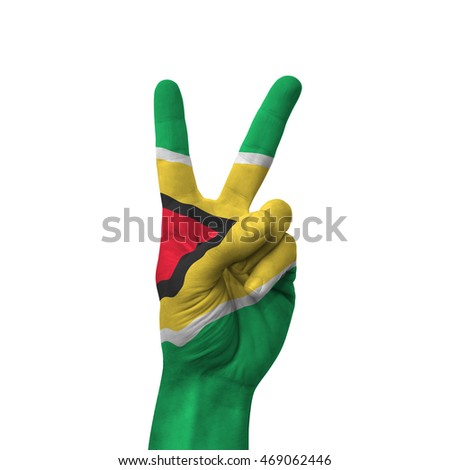 Hand making victory sign, guyana painted with flag as symbol of victory, win, success - isolated on white background