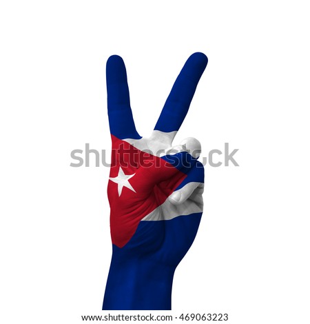 Hand making victory sign, cuba painted with flag as symbol of victory, win, success - isolated on white background