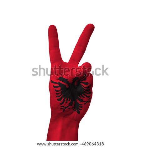 Hand making victory sign, Albania painted with flag as symbol of victory, win, success - isolated on white background