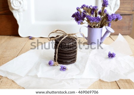 Black chocolate biscuits with flowers decoration