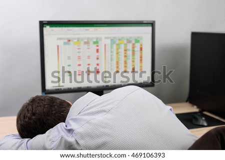 worker fall asleep in office doing business analysis - stock photo