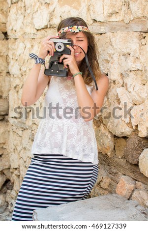 Girl with vintage camera on a old town street