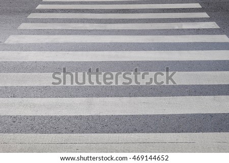 Crosswalk zebra in a city painted on asphalt