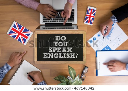 DO YOU SPEAK ENGLISH?                   Business team hands at work with financial reports and a laptop, top view