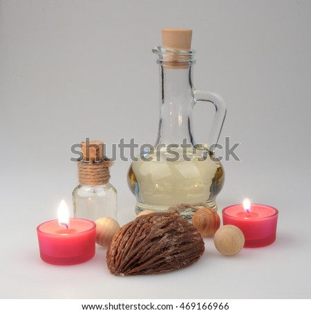 spa composition. scented candles and soap, coffee beans, aromatic wooden balls and oil in a glass jug with a stopper. Photo executed in a light key. partially tinted photo.soft focus
