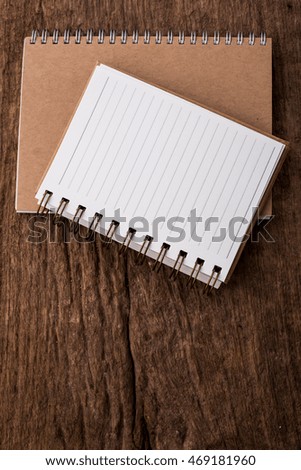 note book on wooden background