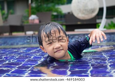 A boy is playing in the swimming pool