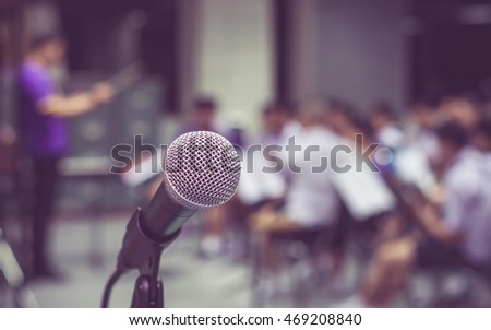 Microphone over the Abstract blurred photo of classic music band when rehearsal, musical and seminar meeting concept