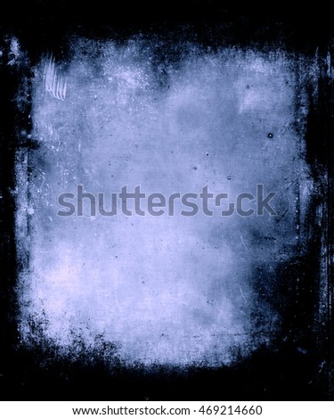 Blue grunge halloween texture background with black frame and faded central area for your text or picture