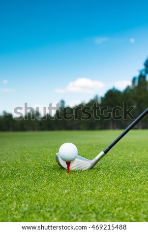 Golf ball and golf club on the course with beautiful background 