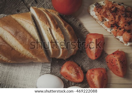 Sandwich with salmon, eggs  and tomatoes