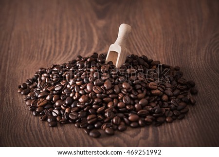 Heap coffee beans on wooden background