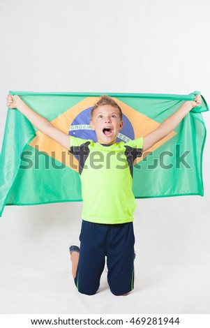 Brazilian patriot and fan boy holding Brazil flag. Football or soccer championship. Support. White background