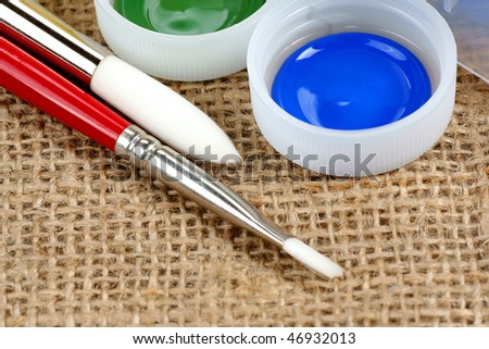 artist brushes with paint jar covers