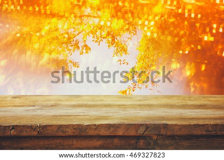 Empty table in front of blurry autumn background. Ready for product display montage