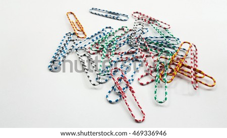 Colorful paper clips design on white background isolate.