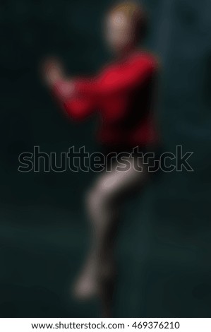 Contemporary dancer wearing red performance abstract blur background with shallow depth of field
