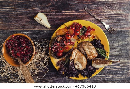 grilled poultry on yellow plate with berries