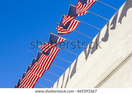 many American flags  with blue sky background on the sunny day.