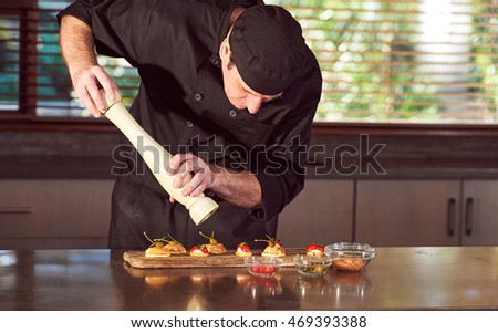 Restaurant hotel private chef preparing making canapes starters  Royalty-Free Stock Photo #469393388