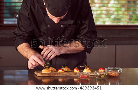 Restaurant hotel private chef preparing making canapes starters  Royalty-Free Stock Photo #469393451