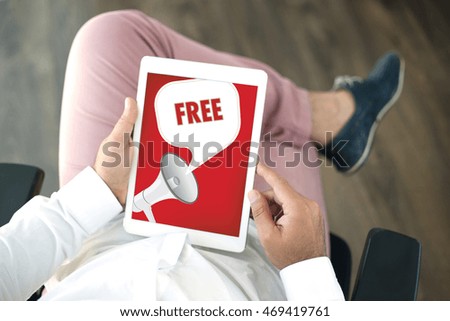 People using tablet pc and FREE announcement concept on screen