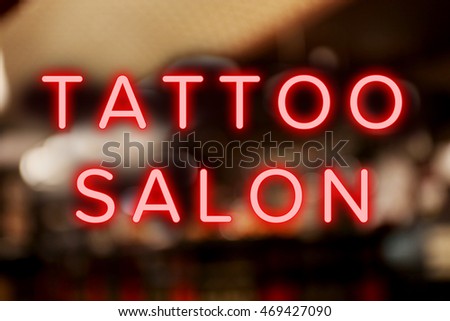 Text Tattoo Salon on blurred background